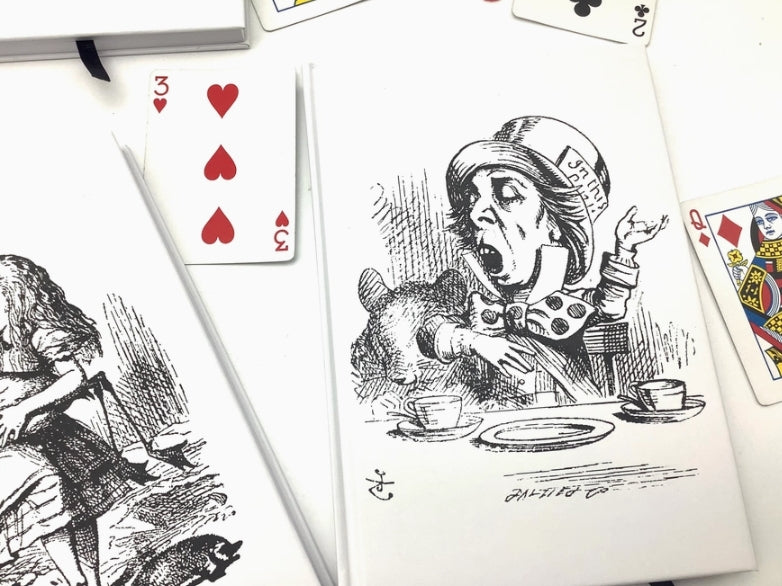 Playing cards with Alice in Wonderland design on a white background