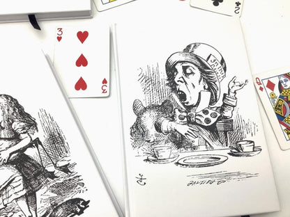 Playing cards with Alice in Wonderland design on a white background