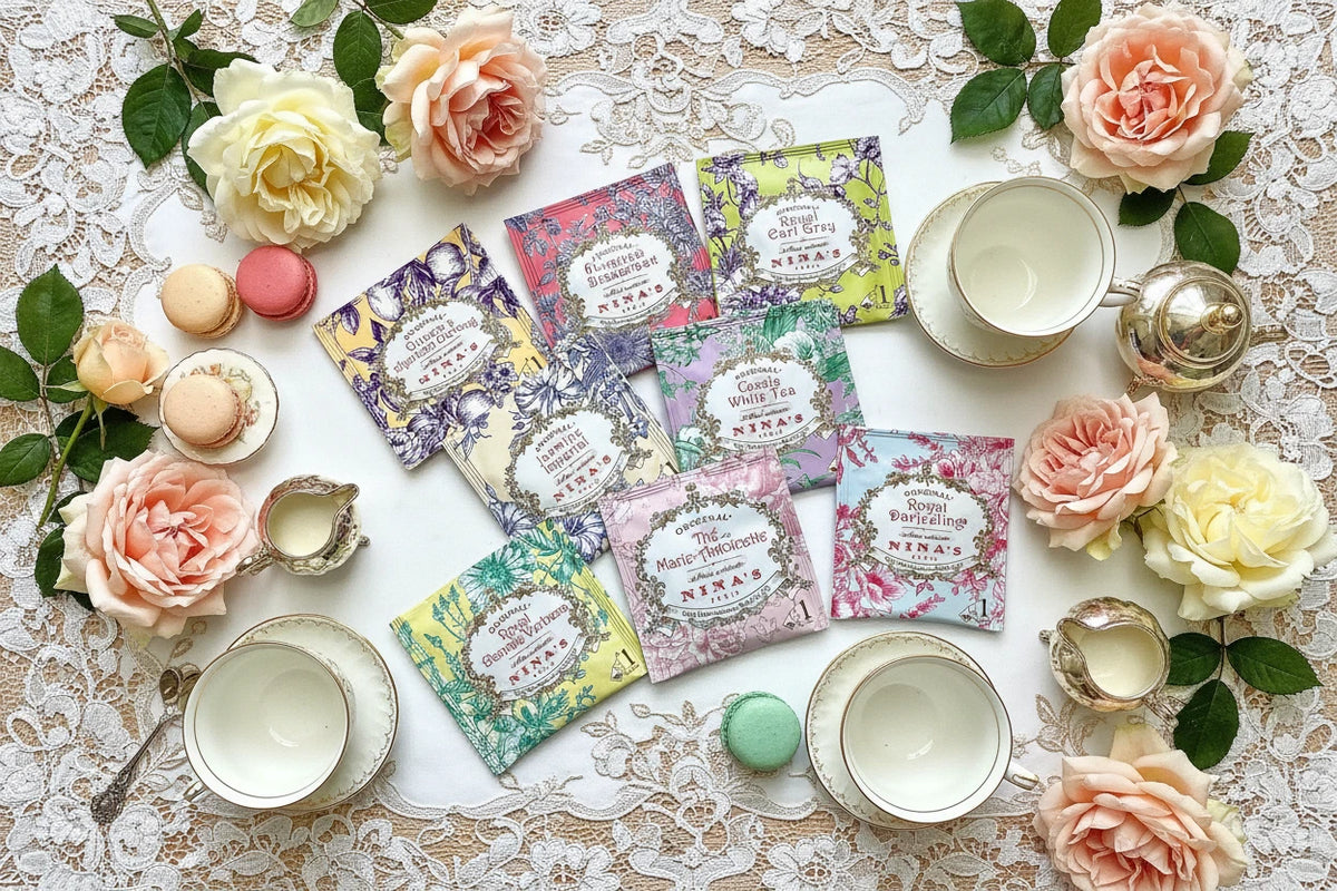 Collection of Nina's tea bags with decorative packaging on a white background