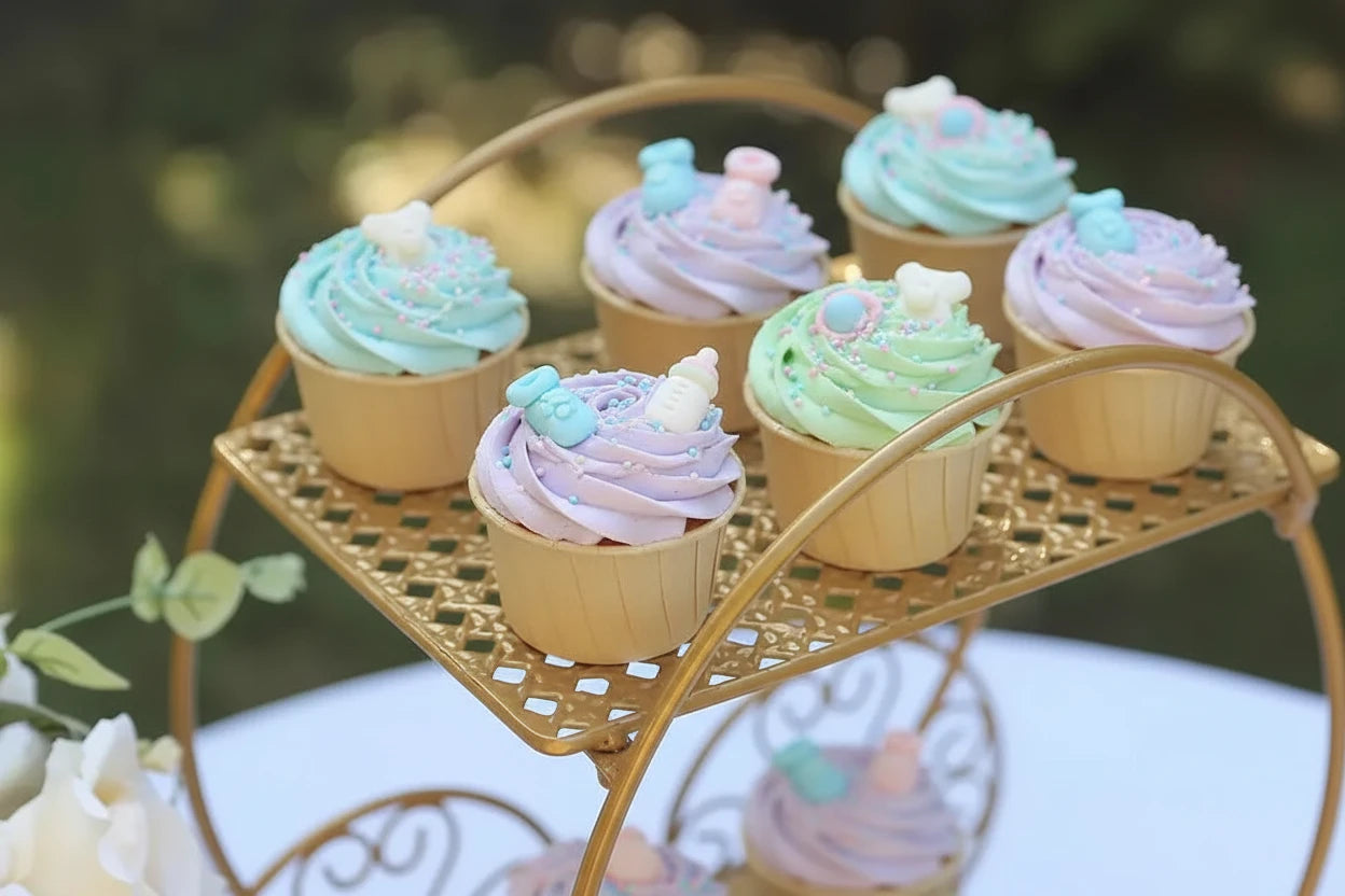 Decorative gold stand with small cupcakes on a blurred natural background