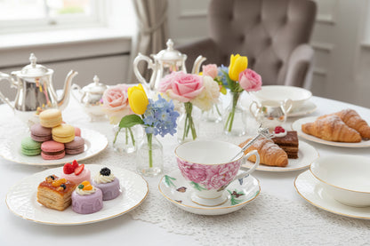 Floral teacup and saucer with a decorative box on a white surface