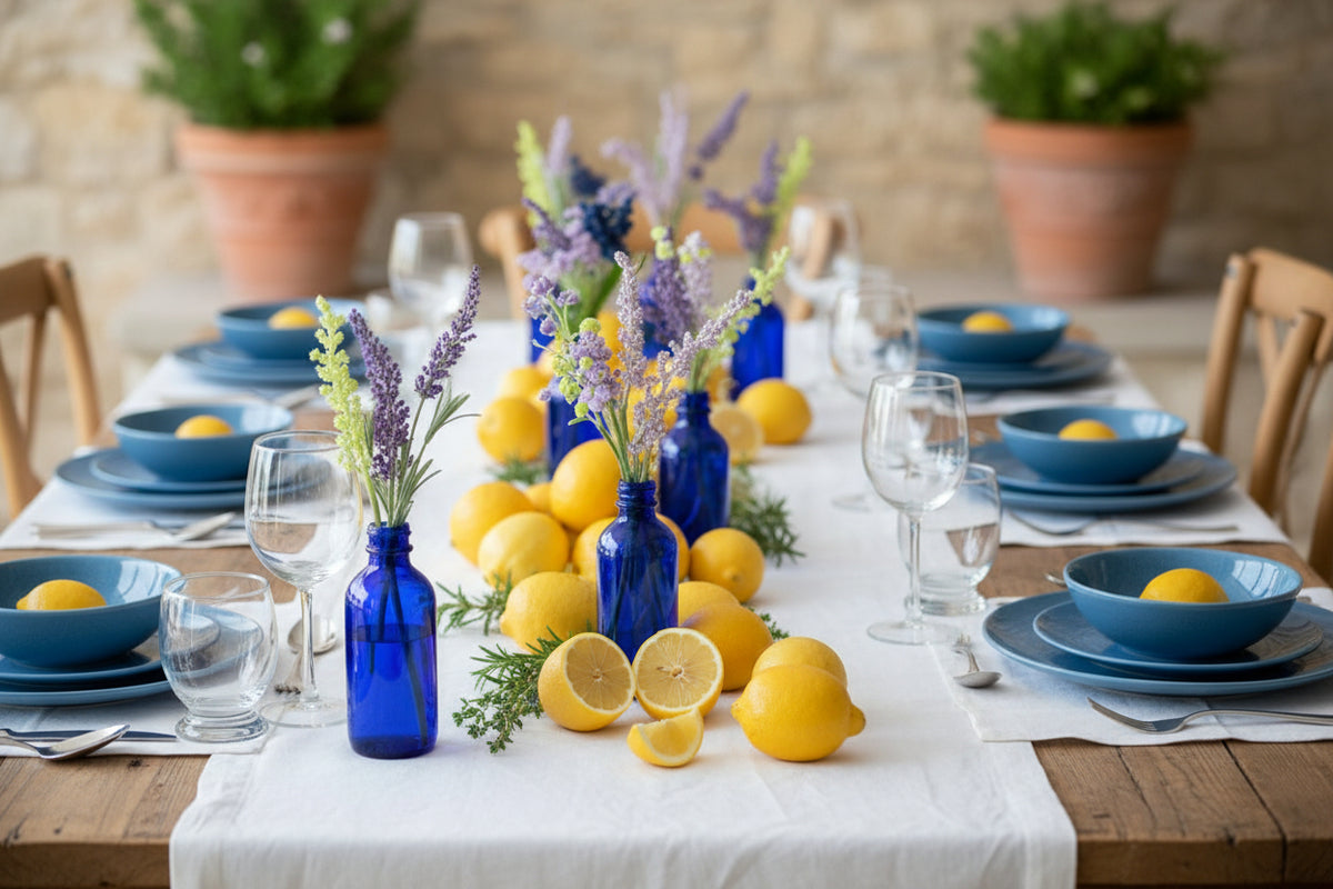 Four blue glass bottles with floral arrangements on a white background